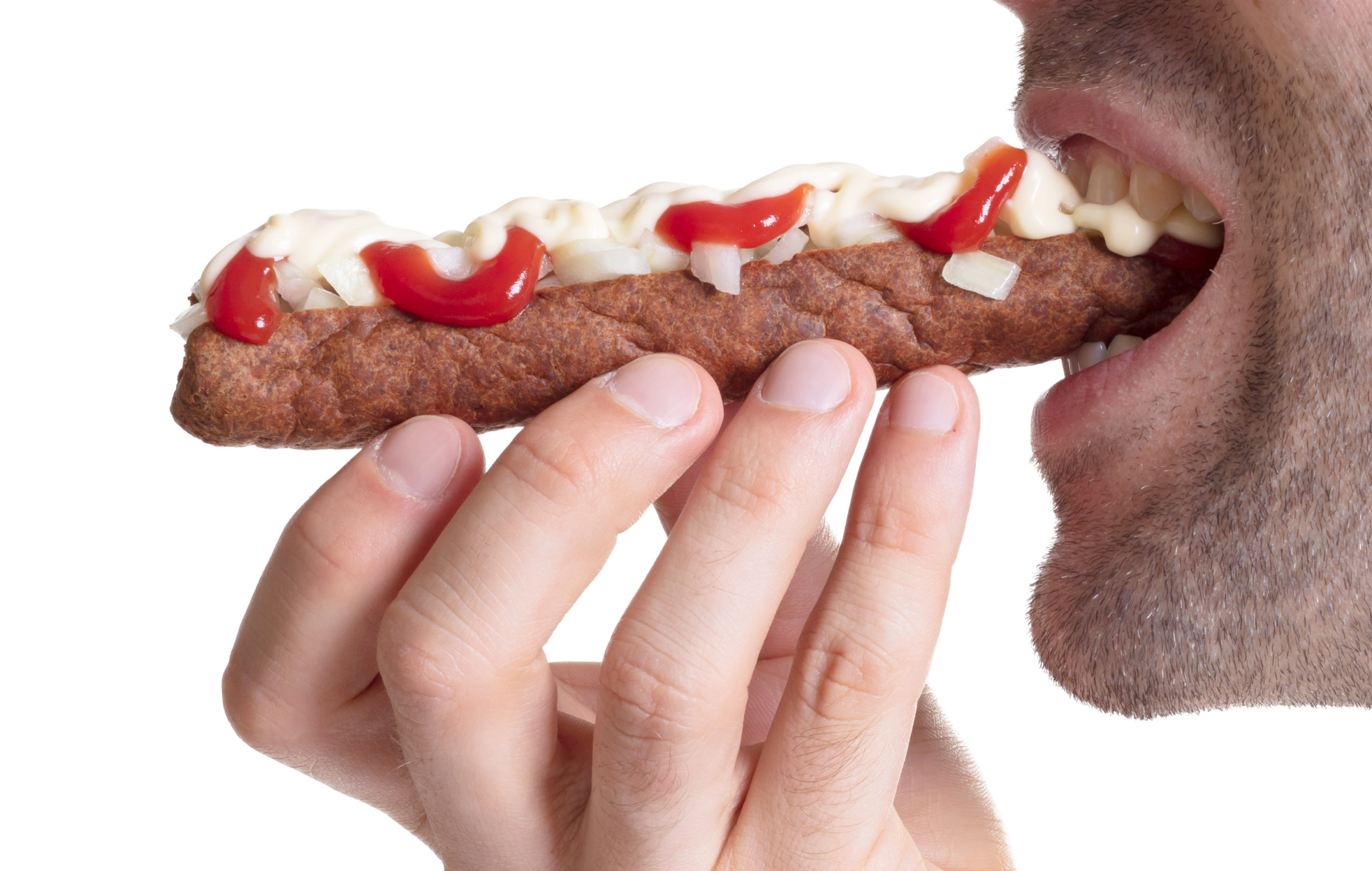 man eating a frikadel with ketchup, mayonnaise on chopped onions